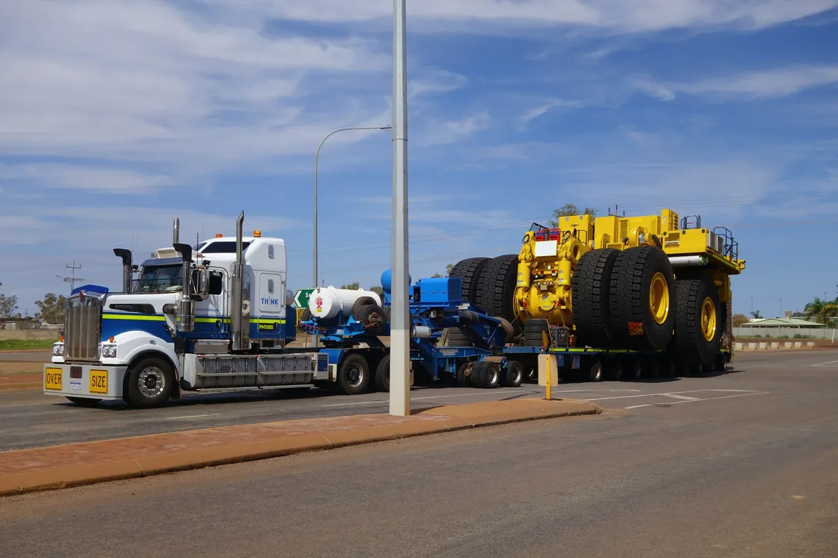 A heavy haulage float carrying an oversize mining vehicle on a Western Australian road